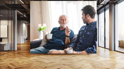 The elderly father and middle-aged son Talking in the house With a coffee cup in hand, Concepts of family and stay at home Wall mural