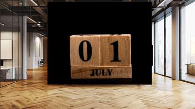 wooden calendar 1 July word on black background with copy space , selective focus at the calendar Wall mural