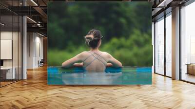 Young Asian woman having relaxation in swimming pool with nature mountain view, summer holiday vacation time for happy enjoy travel lifestyle in water outdoor at beauty resort with blue sky Wall mural