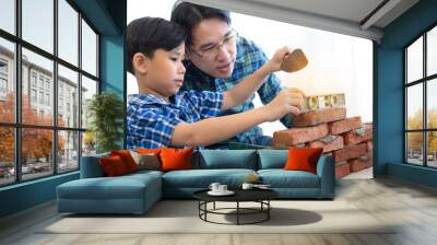 Asian boy learning how to install brick walls with his father, father day, father & son Wall mural