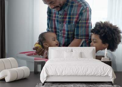 Happy African family, father bathing his baby daughter in bathtub, child boy helping daddy to bath his baby sister Wall mural