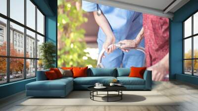 Asian eldery  woman with her caregiver at home. Home care or Elderly care concept. Wall mural