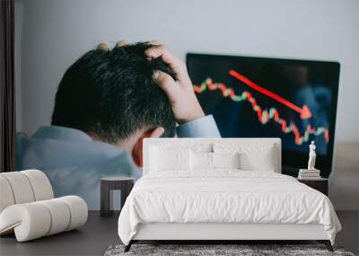 Stress Business man look at to the laptop show financial market chart graphic going down.  Stock market concept. Wall mural