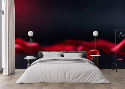 A close-up of a smooth red heart-shaped object on a dark background with elegant red fabric, evoking feelings of love and romance. Wall mural