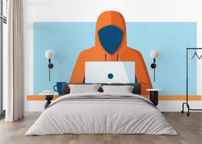 A hooded figure working on a laptop, representing anonymity and cybersecurity themes in a modern digital environment. Wall mural