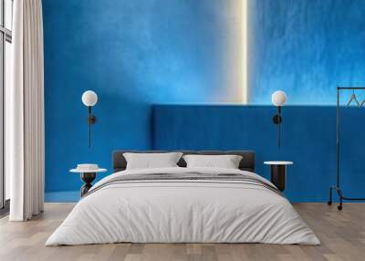 A modern room featuring ambient blue lighting with minimalist design and smooth surfaces. Wall mural