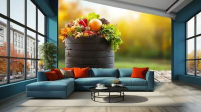 A vibrant basket filled with fresh produce and autumn leaves, set against a beautiful blurred background of nature. Wall mural