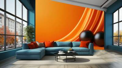 A vibrant orange fabric drapes elegantly alongside two glossy black spheres, creating a striking visual contrast and modern aesthetic. Wall mural