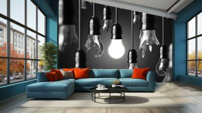 idea concept with broken bulbs and one glowing bulb Wall mural