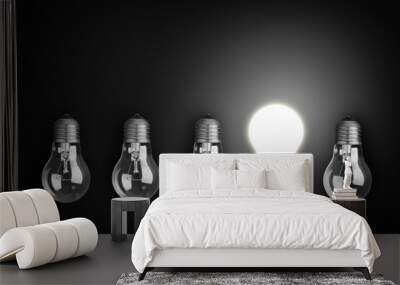 Idea concept with row of light bulbs, one of them is glowing. Wall mural