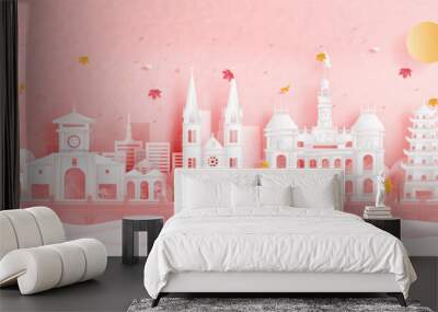 Autumn in Ho Chi Minh City, Vietnam with falling leaves and world famous landmarks in paper cut style vector illustration Wall mural