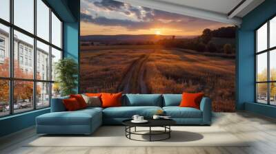 A sun is setting over a field of tall grass Wall mural