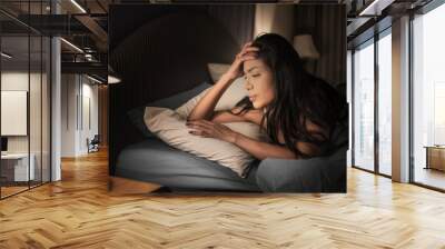 Sadly depressed women suffer from insomnia, she sleep in bed and touching her forehead, sleep disorder and stress concept. Wall mural