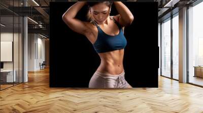 Sporty woman workout while Cropped studio shot of a stunning hot sporty body of a fitness woman Wall mural