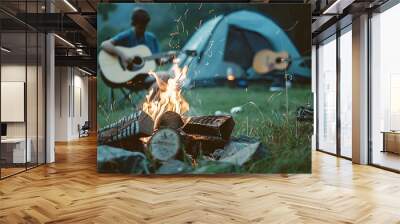 A man is playing a guitar next to a campfire Wall mural