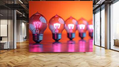 A row of glowing pink light bulbs on a table Wall mural