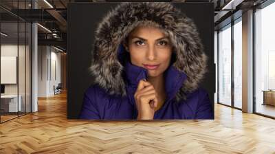 Headshot of beautiful Asian Indian woman in purple, furry hooded winter coat.  Wall mural