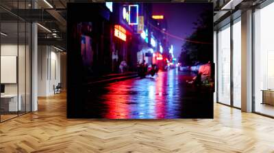 Neon lights at night in Shanghai, China. Shot on a rainy night on the backstreets. Normal life in this busy city. Blues, reds and orange run through this image, with strong coloured reflections Wall mural