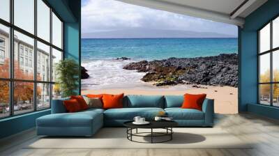 Private beach with sand and lava rocks in Maui Hawaii Wall mural