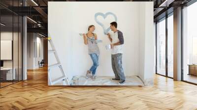 Couple painting blue heart on wall Wall mural