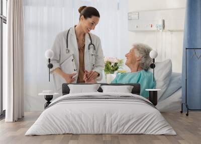 Doctor and senior patient talking in hospital room Wall mural