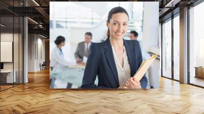 Portrait of smiling businesswoman in meeting with doctors Wall mural