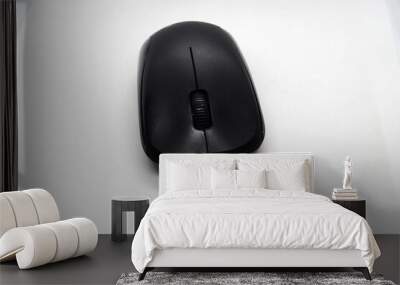  black wireless mouse  over a white background Wall mural