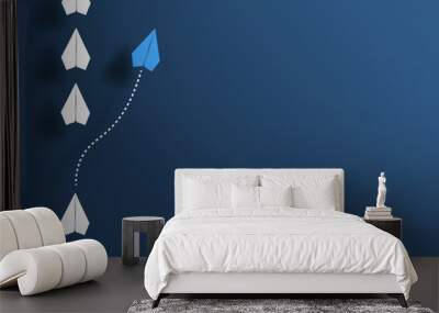 paper planes in a row on blue background and one paper glider going in different direction, breaking new ground and stepping out of the line concept Wall mural