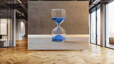 hourglass wiht blue sand on a black background Wall mural