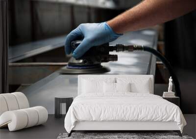 Man using orbital sander to prepare a metal panel Wall mural