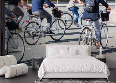 group of people riding bicycle on a city street Wall mural