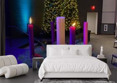 Partially Lit Christmas Advent Wreath in a Church Setting Wall mural