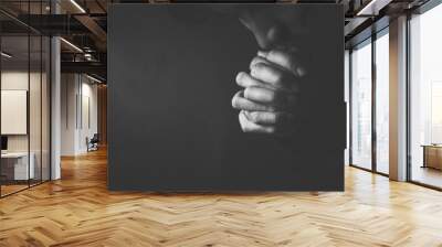 Praying Man Against Dark Background With Copy Space Wall mural