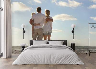 happy family on beach vacation looking at ocean Wall mural