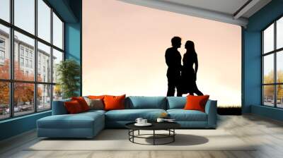 Happy Young Couple in Love Silhouetted Against Sunset in the Sky Wall mural