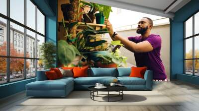 african earth lover portrait captured at home with his plants in his nursery Wall mural