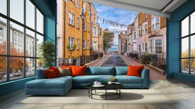 A view along Addington Street, Ramsgate toward the sea. Bunting is flying in preparation for the annual street fair. The street is part of Ramsgate's burgeoning music and art scene. Wall mural