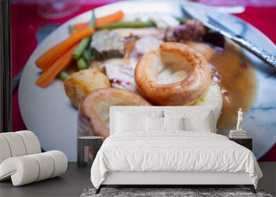 Two Yorkshire puddings on a plate of Christmas roast dinner. There are carrots and green beans, plus roast potatoes and turkey on the plate with gravy. Wall mural