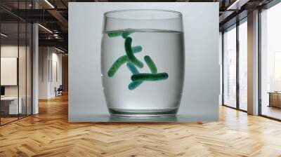 Illustrative representation of drinking water contaminated with bacteria and pathogens in a drinking glass Wall mural