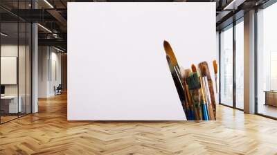 Paint brushes in a pot against a white background Wall mural