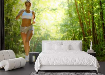 pretty young girl runner in the forest. Wall mural