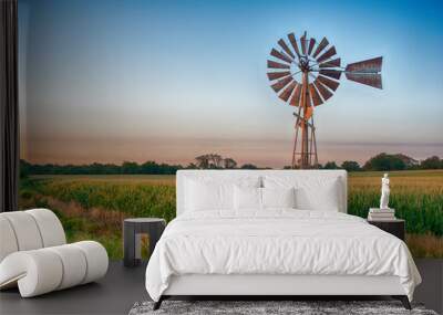 Vintage windmill at sunset with cornfield. Wall mural