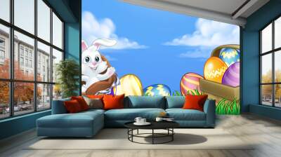 The Easter bunny rabbit breaking out of a chocolate Easter egg in an outdoor scene Wall mural