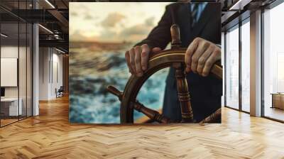 Businessman hands on ship's wheel, navigating through rough seas concept of leadership and marketing strategy business man in suit standing at the helm steering boat on blurred background Wall mural