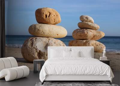 two stack of pebble on sandy beach Wall mural