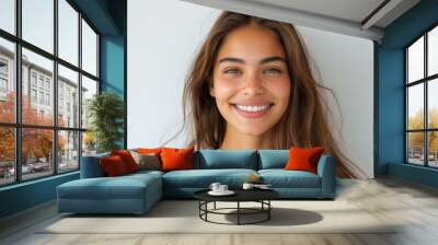 Smiling young woman in casual attire against white background, ideal for positive lifestyle content. Wall mural