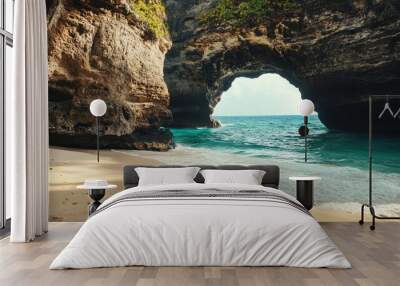 A scenic beach view featuring a natural rock arch and clear turquoise waters. Wall mural