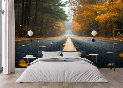 A serene autumn road lined with golden leaves, creating a peaceful atmosphere for travel and exploration. Wall mural