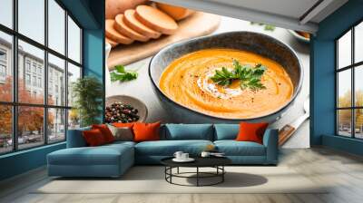 Sweet potato cream soup in a ceramic bowl on a light background, selective focus Wall mural