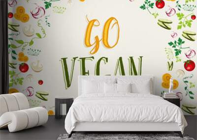 Raw vegetable background with go vegan text Wall mural